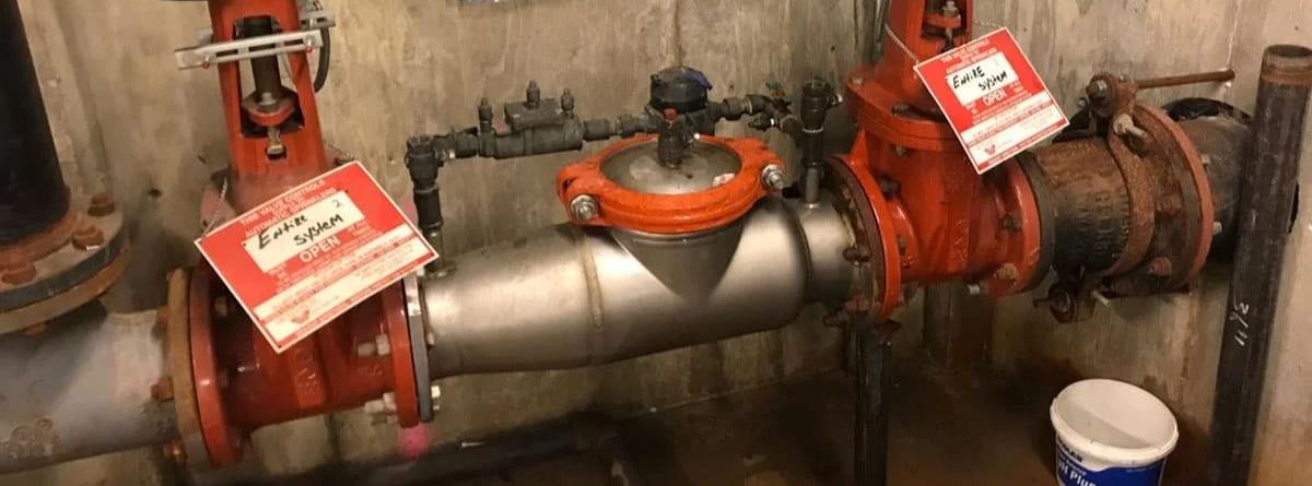 Plumber testing a backflow prevention device in Lancaster, CA