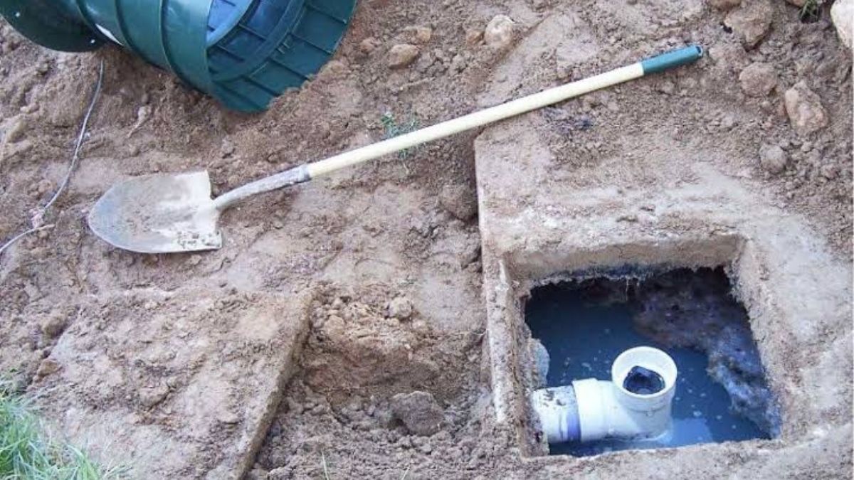 Plumber repairing a septic tank component in Lancaster, CA