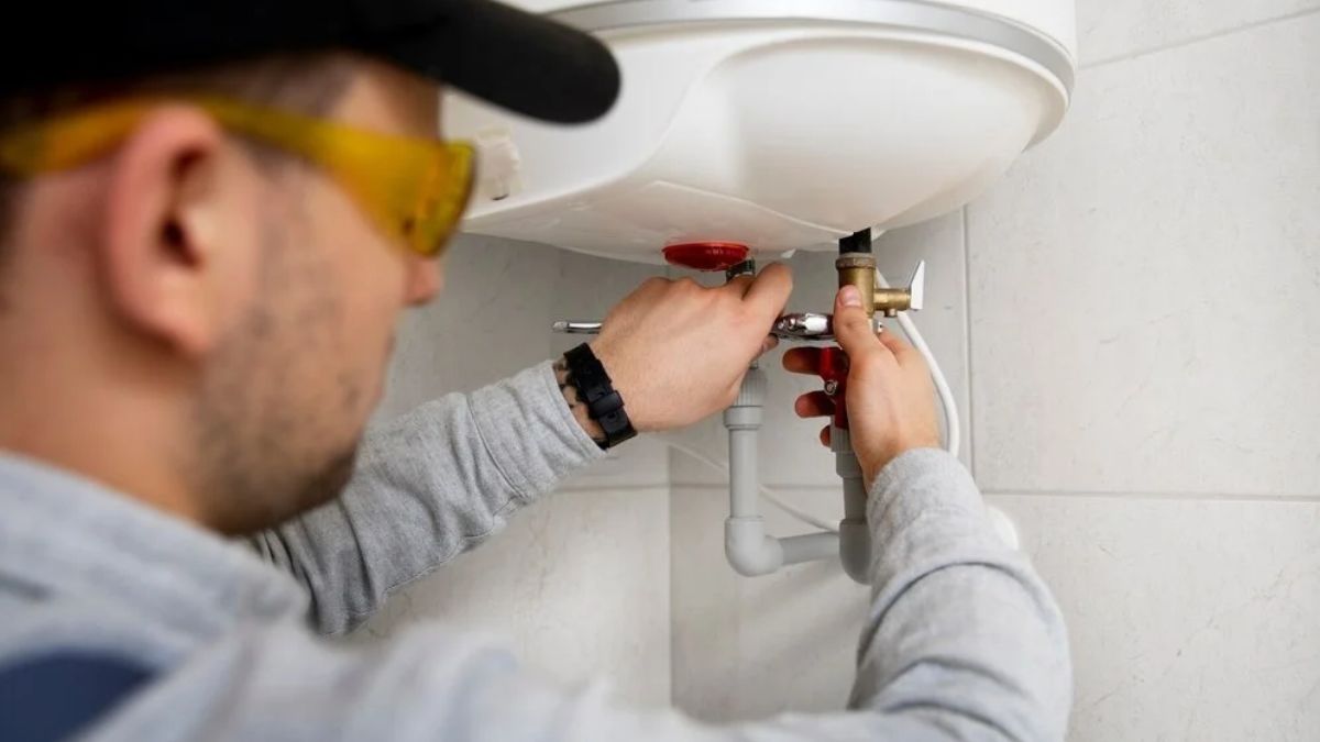 Plumber repairing a pipe in a Lancaster, CA home